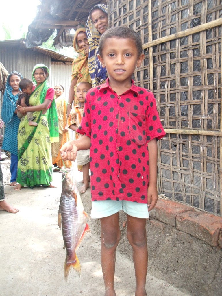 Boy holding a pangasius catfish (photograph by Ben Belton)