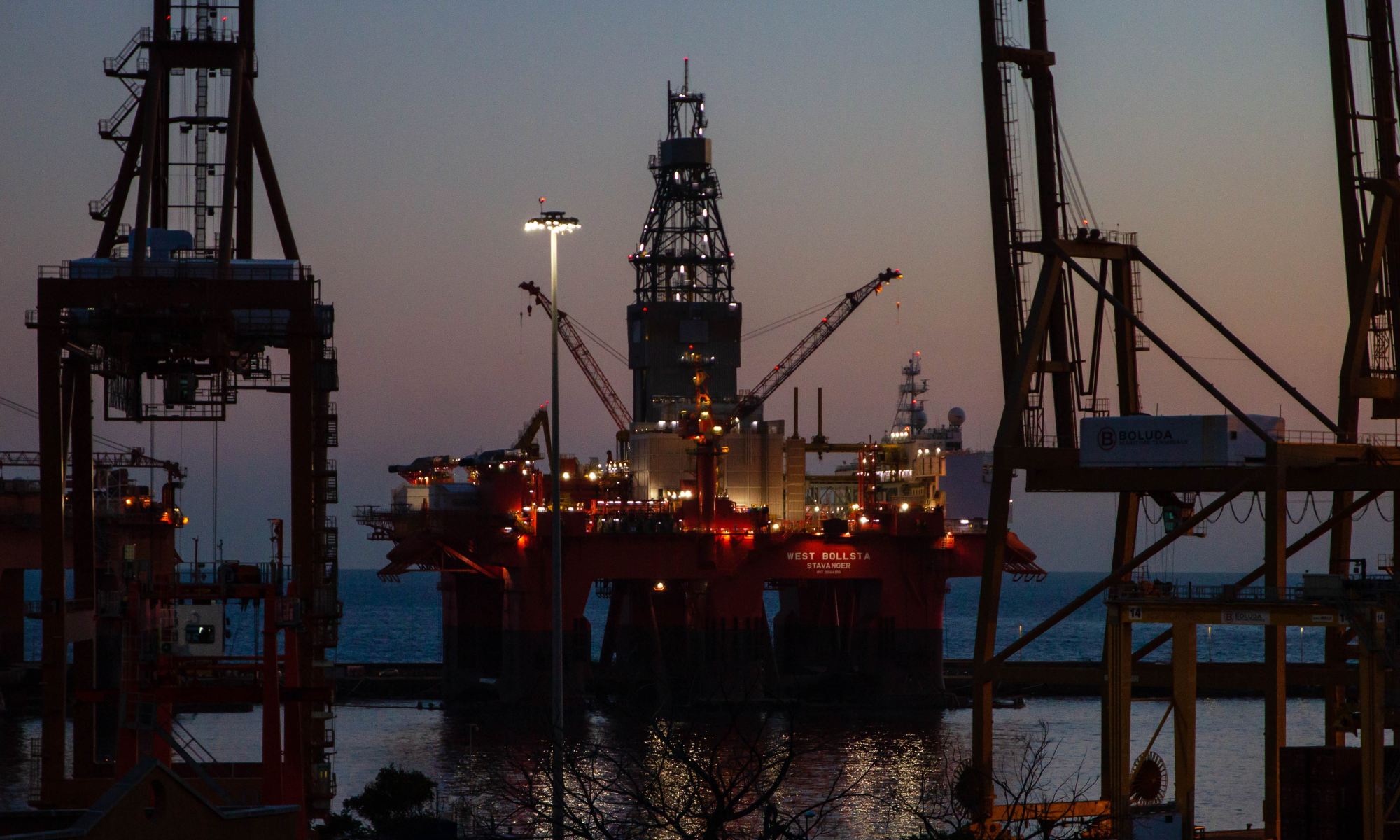 Dock with West Bollsta semi-submersible drilling rig (a vessel in the Oil service segment) on the Tenerife island during sunset