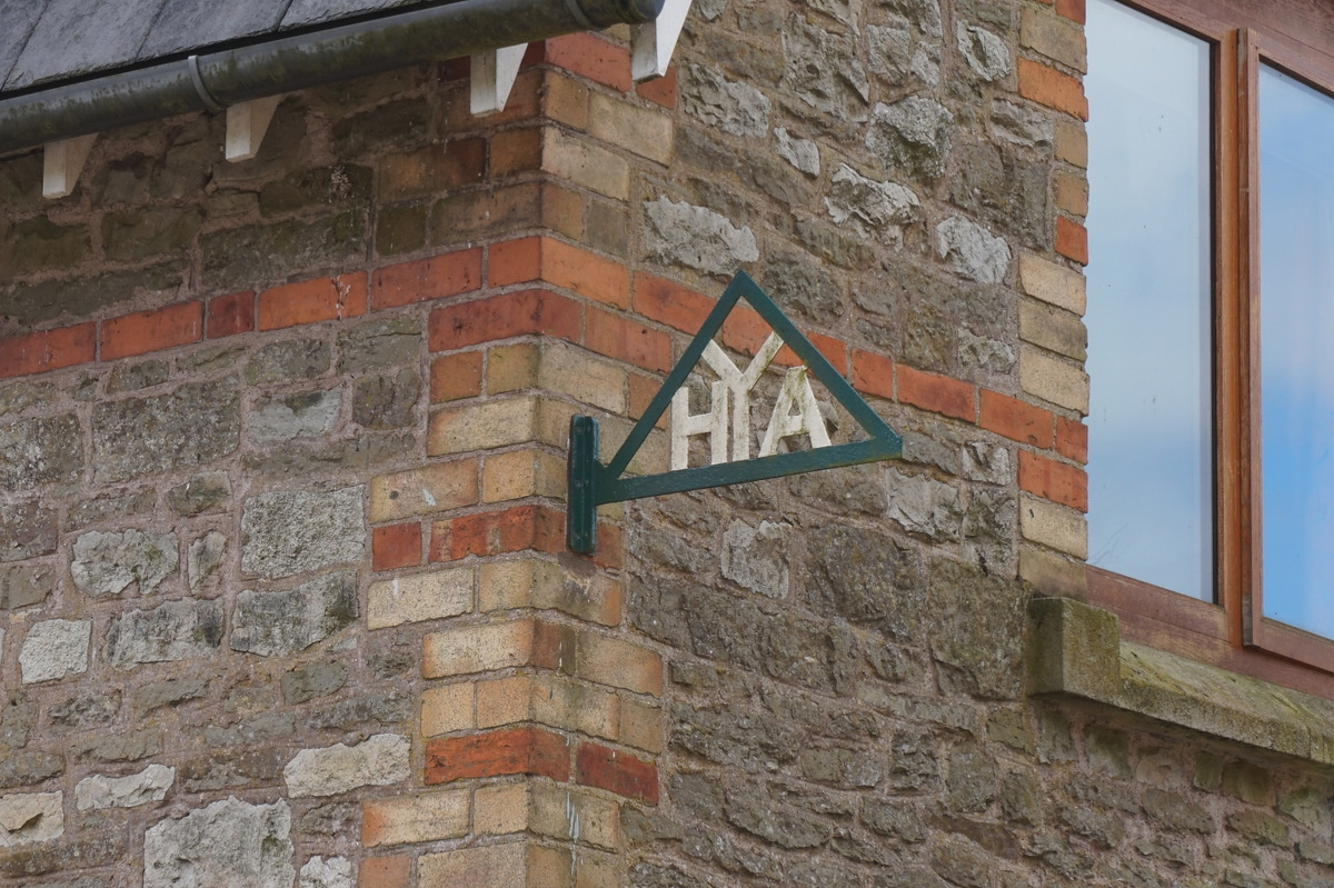 A YHA sign on a brick building