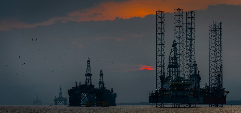 A group of oil rigs in the ocean.