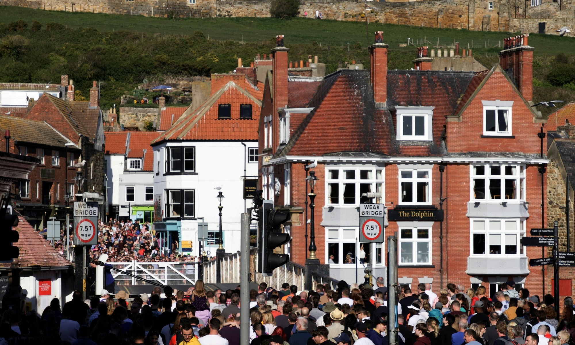 A crowd of people in a street.