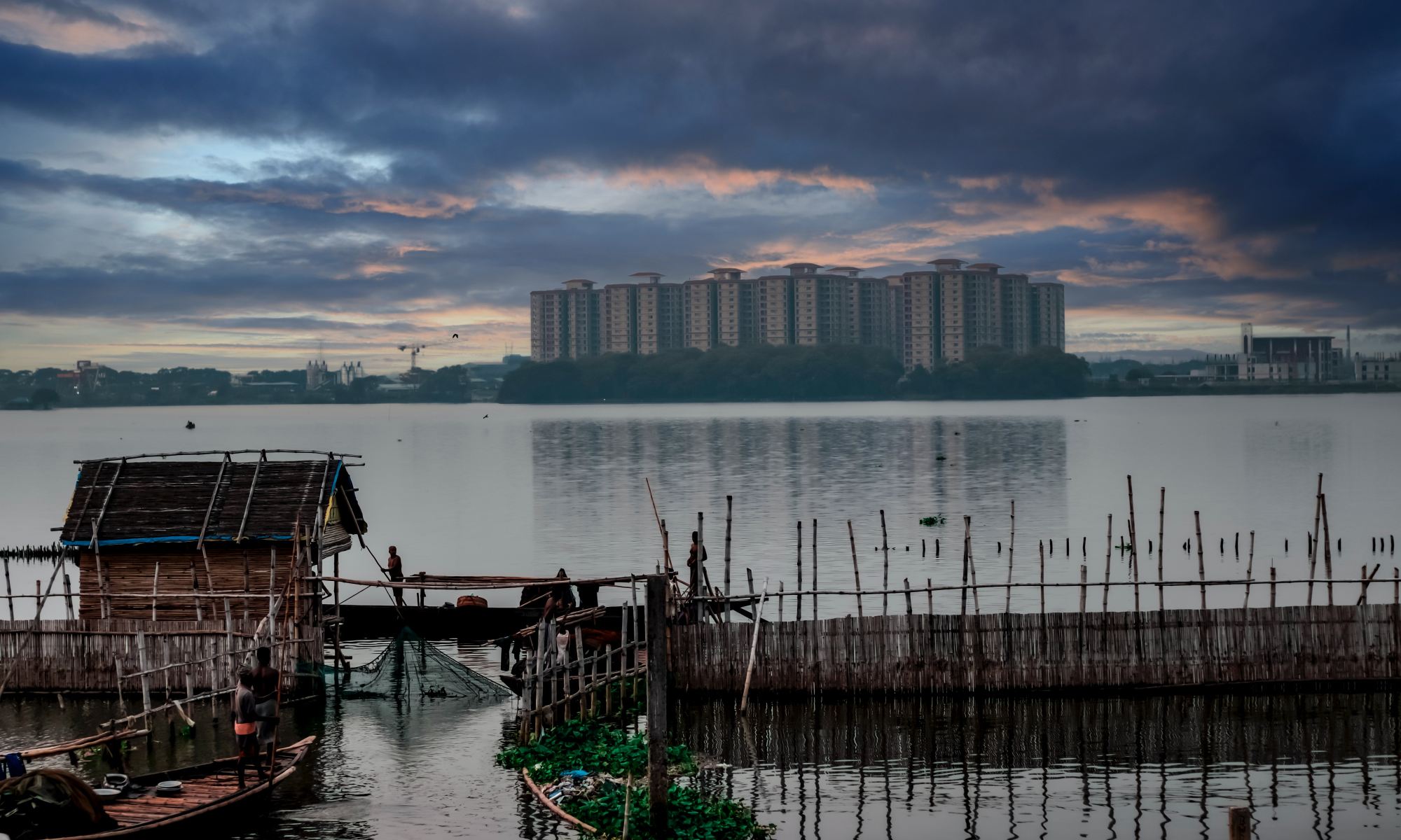A body of water with flats in the background and a dock in the foreground.